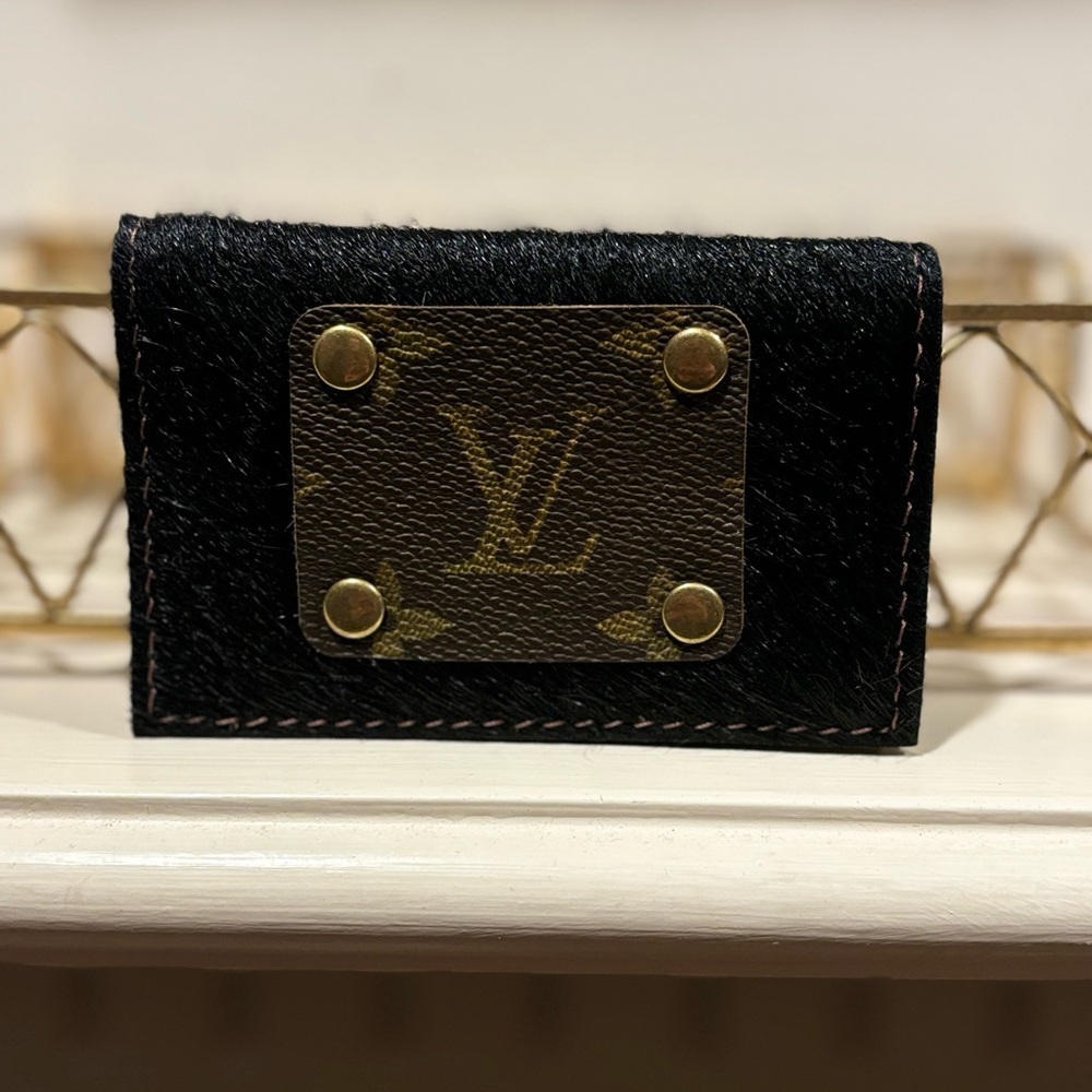 Repurposed LV car holder in a black cow hide